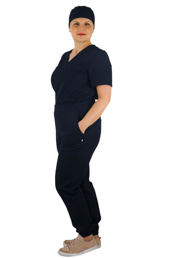 Active Stretch Kasack, Hose und Haube für Damen in Marineblau – seitliche Pose – elastische, bequeme und stilvolle Berufsbekleidung für den Arbeitsalltag.